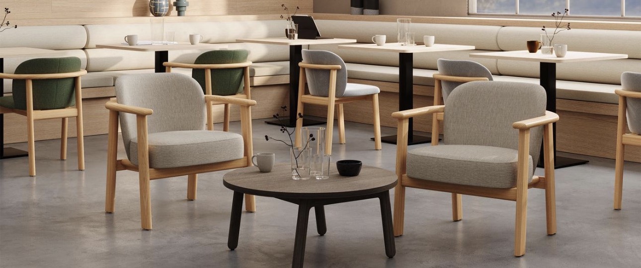 Lounge chairs and café tables in a warm wood-toned hospitality seating area